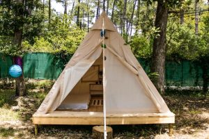 Wooden floors and bedding in our glamping tents